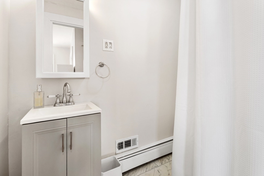 52 Chestnut Street Wakefield, MA 01880 - Photo 31 of 42 a bathroom with a sink a vanity and a mirror