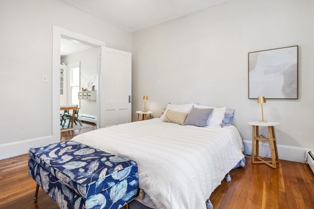 52 Chestnut Street Wakefield, MA 01880 - Photo 33 of 42 a bedroom with a bed and a table in it