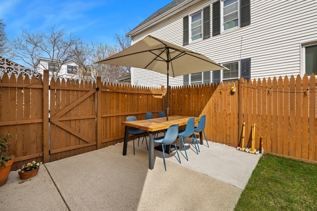 52 Chestnut Street Wakefield, MA 01880 - Photo 37 of 42 a backyard of a house with table and chairs