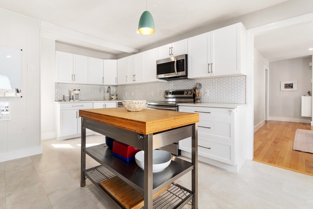 52 Chestnut Street Wakefield, MA 01880 - Photo 4 of 42 a kitchen with stainless steel appliances a stove a sink cabinets and a refrigerator
