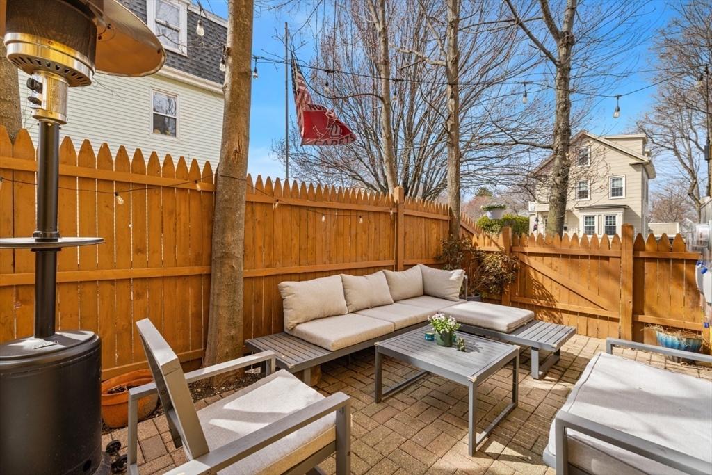 52 Chestnut Street Wakefield, MA 01880 - Photo 42 of 42 a view of a patio with a table and chairs