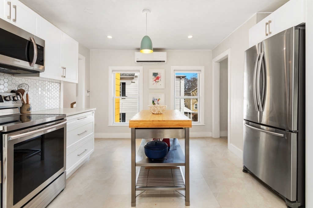 52 Chestnut Street Wakefield, MA 01880 - Photo 6 of 42 a kitchen with stainless steel appliances granite countertop a refrigerator a stove and a microwave