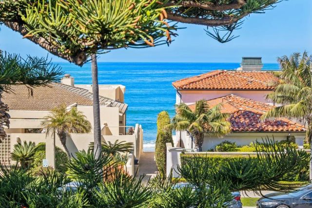 an empty room with wooden floor and fireplace