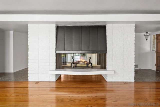 a view of wooden floor and windows in a room