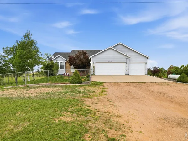 a house with huge green field in front of it