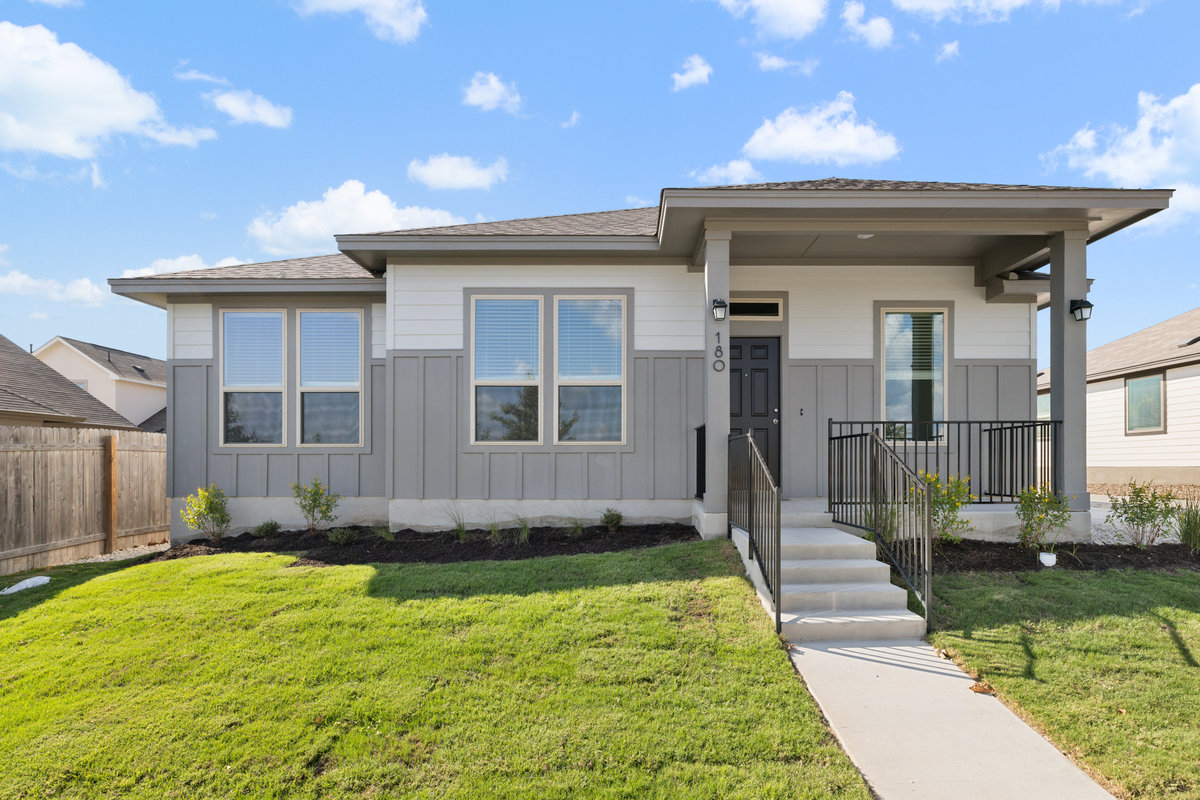180 Condesa Street Kyle, TX 78640 - Photo 1 of 1 a view of a house with a small yard and a large tree