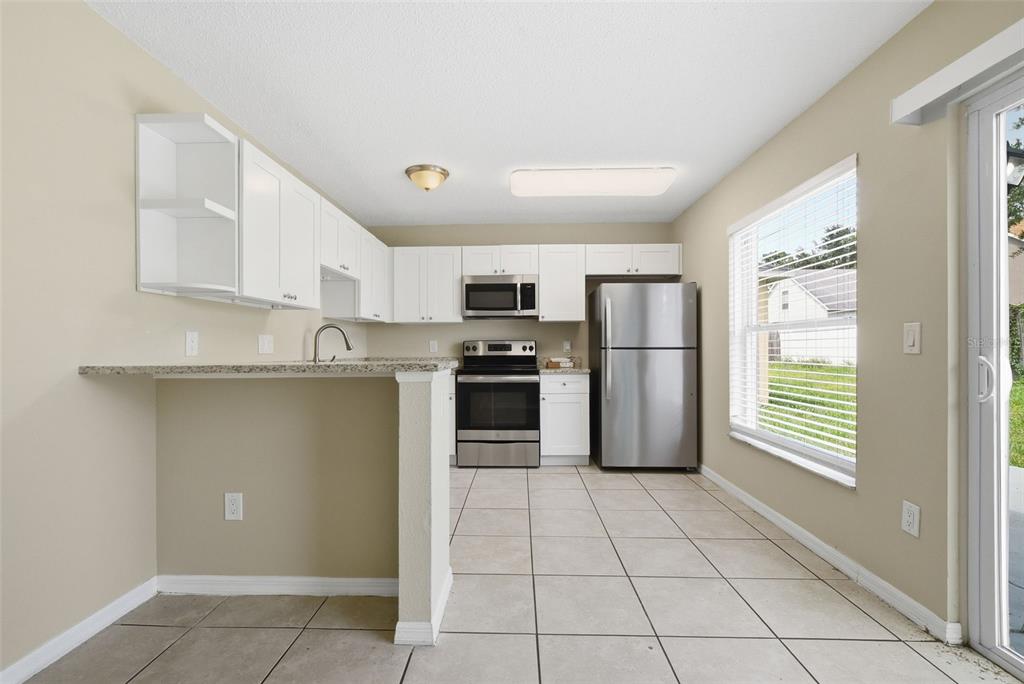 617 Greys Ferry Road Orlando, FL 32811 - Photo 13 of 35 a kitchen with stainless steel appliances granite countertop a refrigerator and a sink