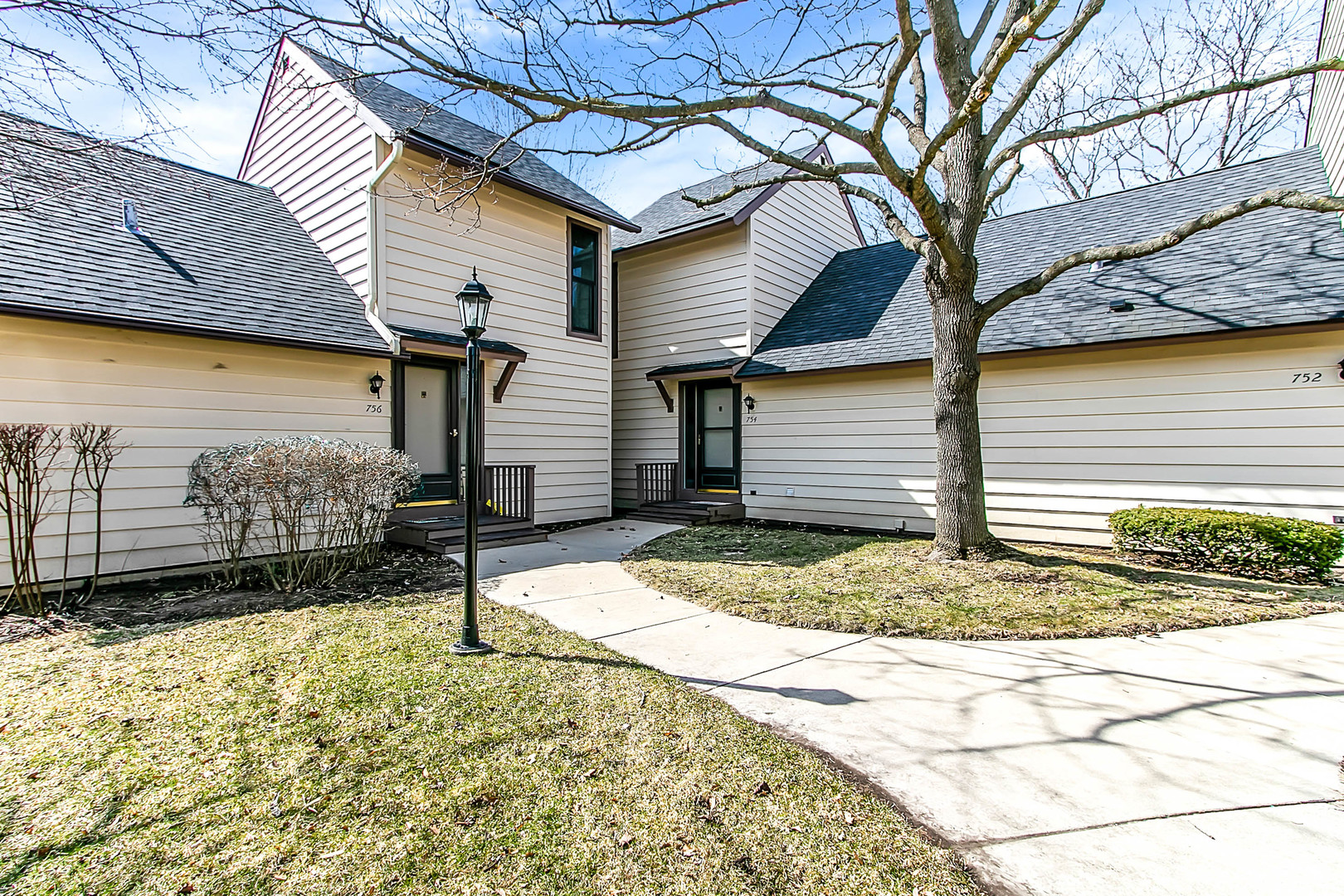 754 Chandler Road Gurnee, IL 60031 - Photo 1 of 34 a front view of a house with a yard