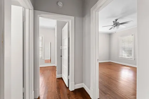 a view of a hallway with wooden floor
