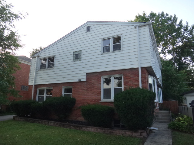 192 East Quincy Street Riverside, IL 60546 - Photo 1 of 11 a front view of a house with a garden