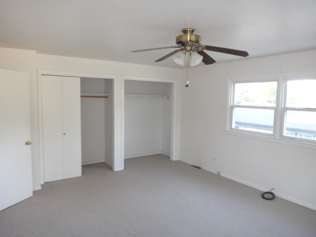 192 East Quincy Street Riverside, IL 60546 - Photo 6 of 11 an empty room with a window and a fan
