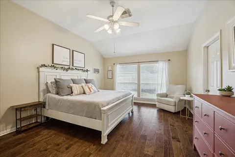 a bedroom with a large bed and a dresser