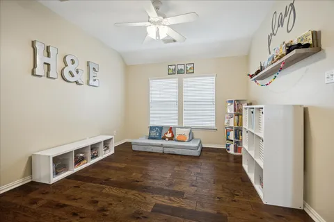 a bedroom with furniture and a book shelf