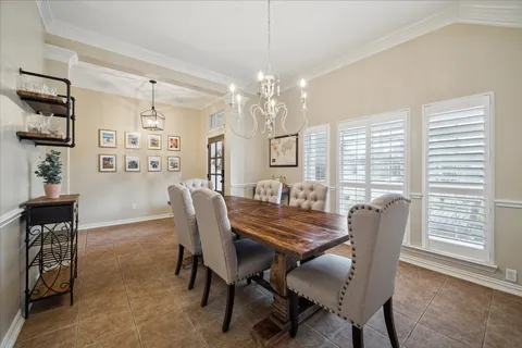 a view of a dining room with furniture and a chandelier