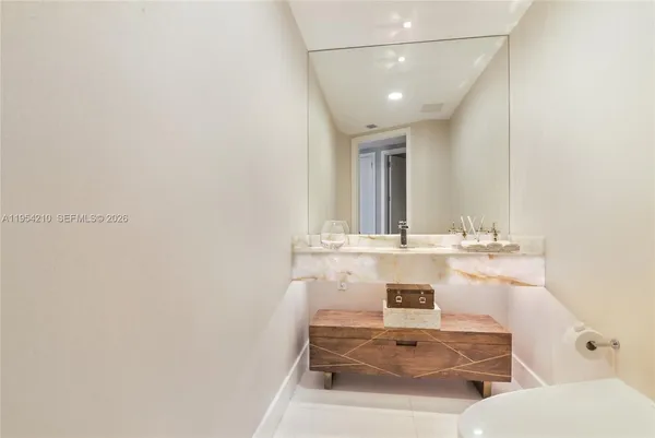 a bathroom with a sink vanity and mirror