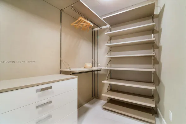 a view of walk in closet with empty racks