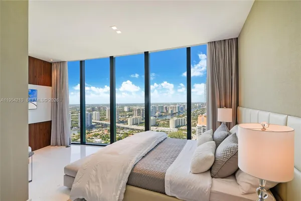 a bedroom with a large bed and a large window