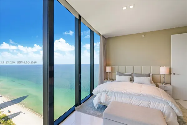 a bedroom with a large bed and a balcony view