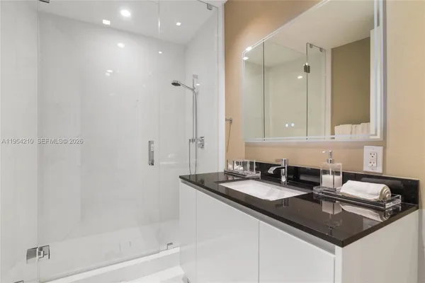 a close view of a sink a counter and cabinets in a kitchen