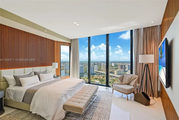 a bedroom with a bed and a large window