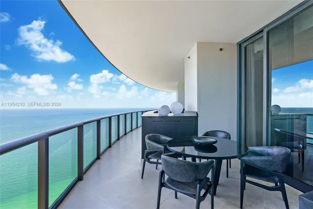 a view of a chairs and table in the balcony
