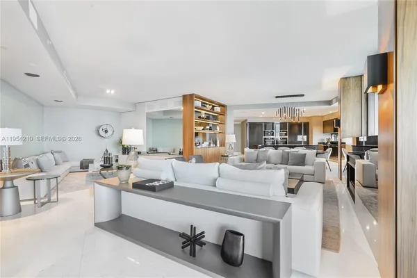 a large room with a lot of white furniture and a couch