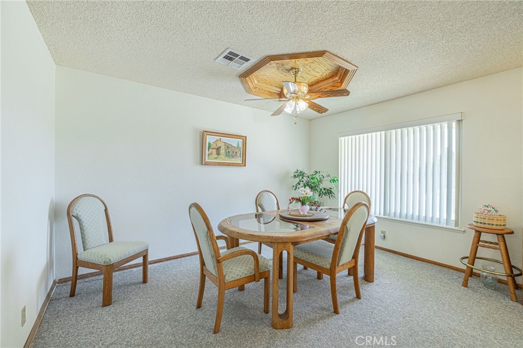 8541 West Ave D Lancaster, CA 93536 - Photo 15 of 62 a view of a dining room with furniture and chandelier