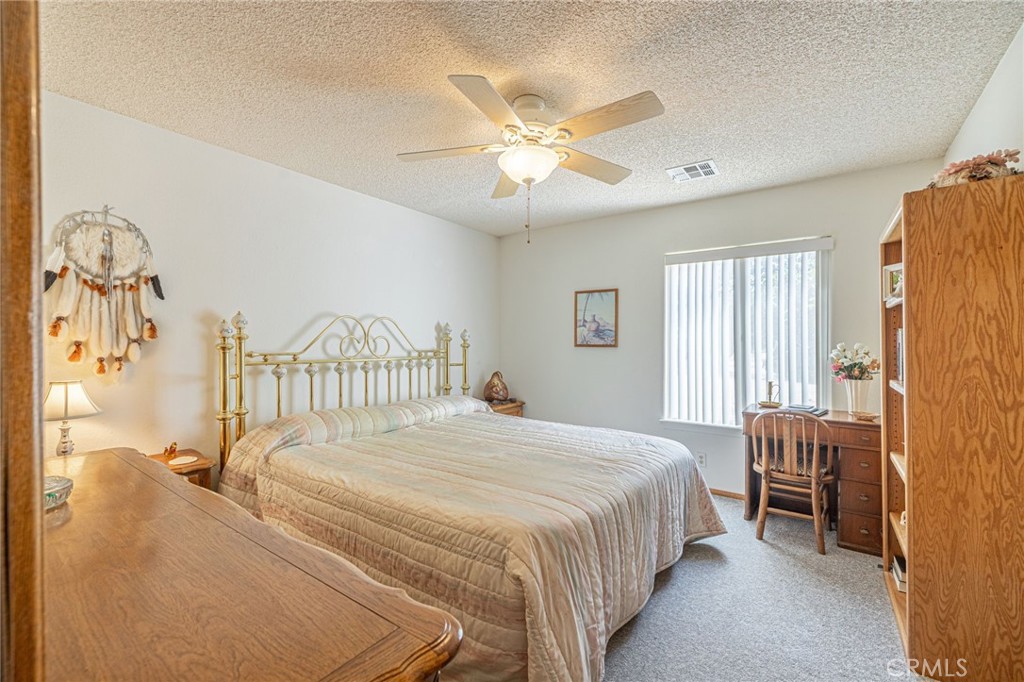 8541 West Ave D Lancaster, CA 93536 - Photo 17 of 62 a bedroom with a bed and a chandelier