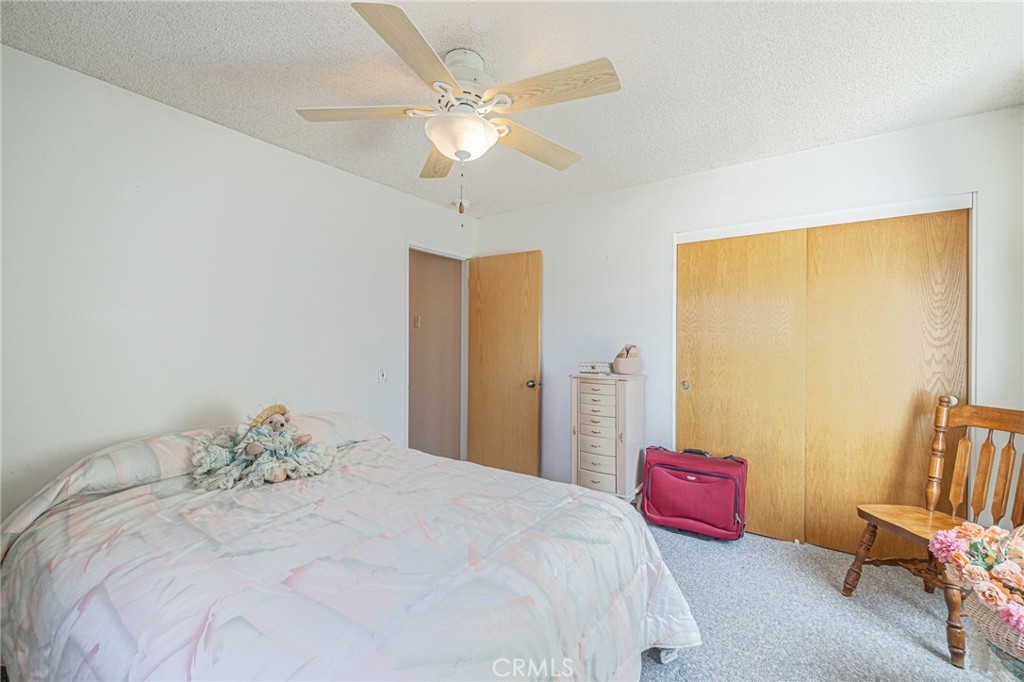 8541 West Ave D Lancaster, CA 93536 - Photo 20 of 62 a bedroom with a bed and a chandelier