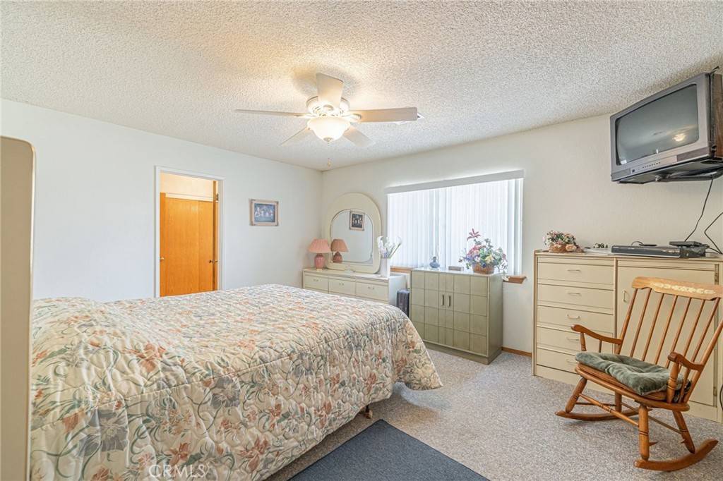 8541 West Ave D Lancaster, CA 93536 - Photo 23 of 62 a bedroom with a bed and a chair