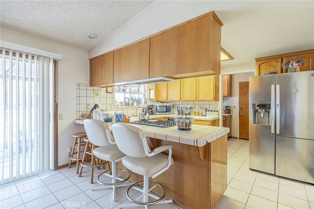 8541 West Ave D Lancaster, CA 93536 - Photo 31 of 62 a dining table chair next to a window