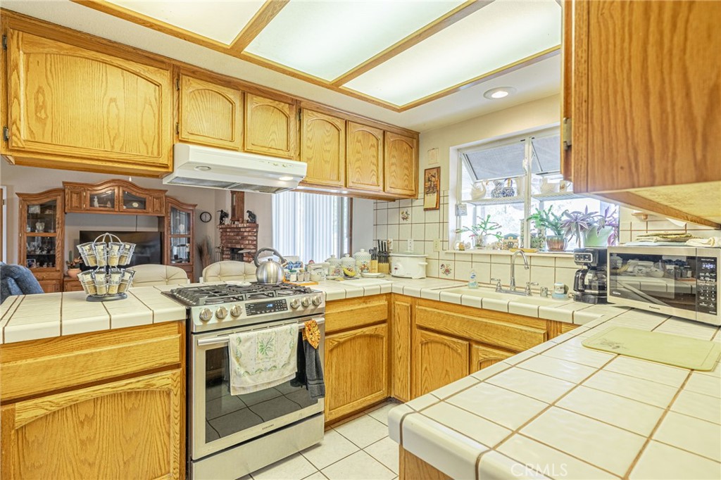 8541 West Ave D Lancaster, CA 93536 - Photo 32 of 62 a view of a kitchen with stainless steel appliances granite countertop a sink and cabinets