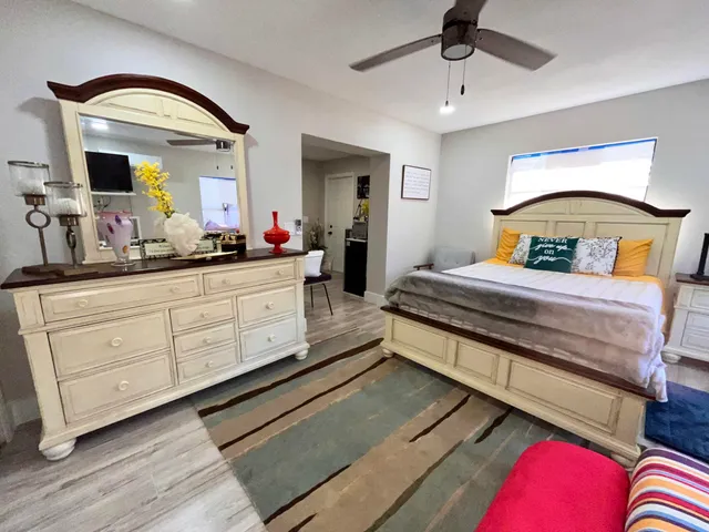 a bedroom with bed and window with lamp