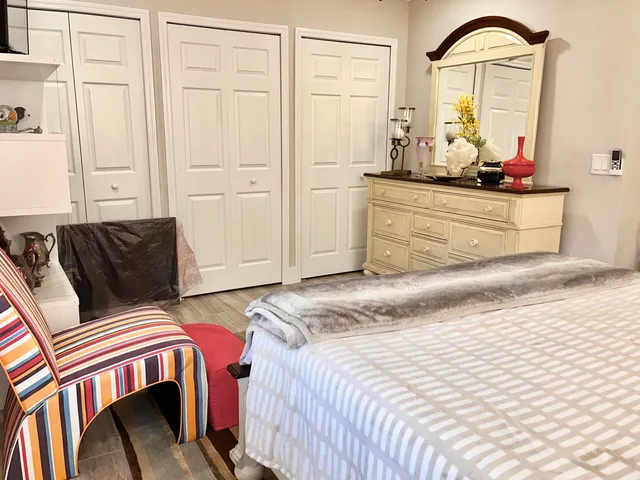 a bedroom with a bed and dresser