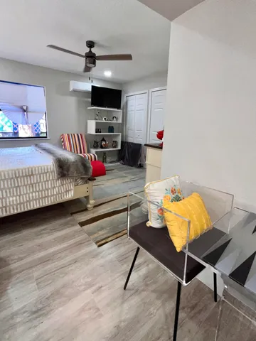 a bedroom with furniture and a wooden floor