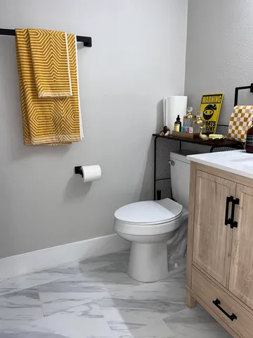 a bathroom with a toilet sink and vanity