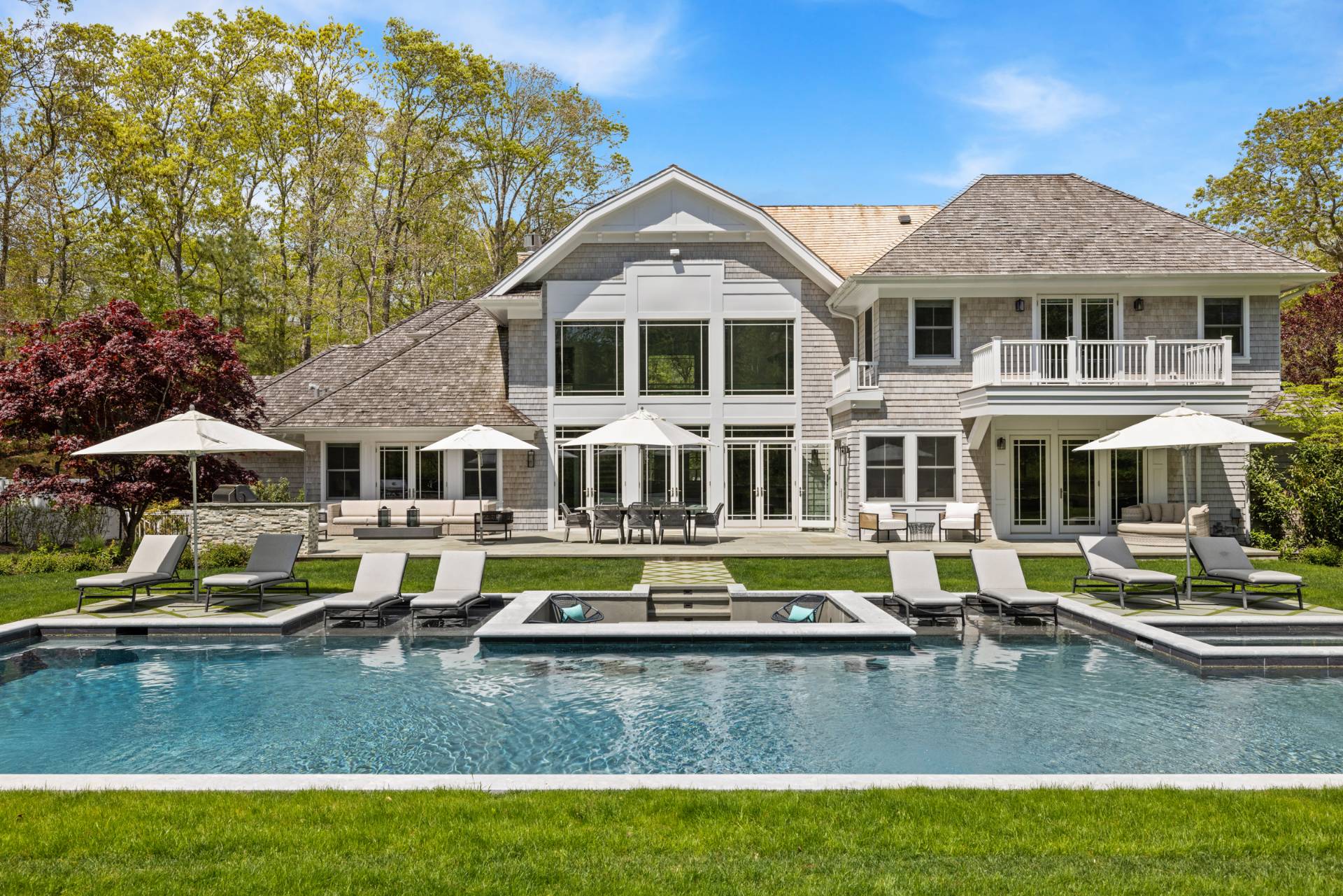 8 Shady Pth Bridgehampton, NY 11963 - Photo 5 of 45 a white house sitting next to a yard with large trees