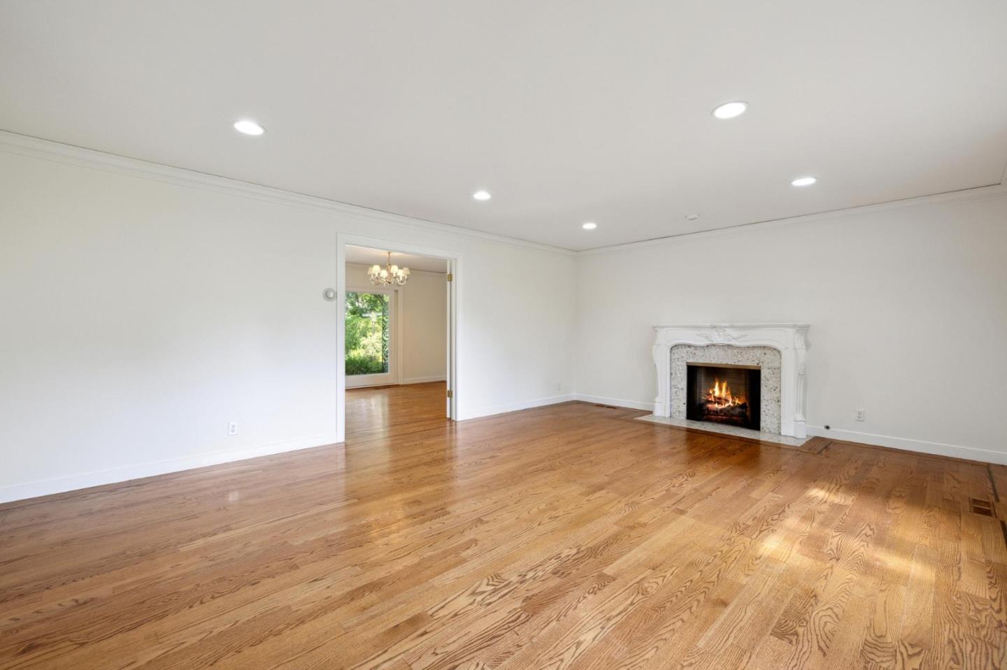 243 Selby Lane Atherton, CA 94027 - Photo 12 of 90 an empty room with wooden floor and fireplace