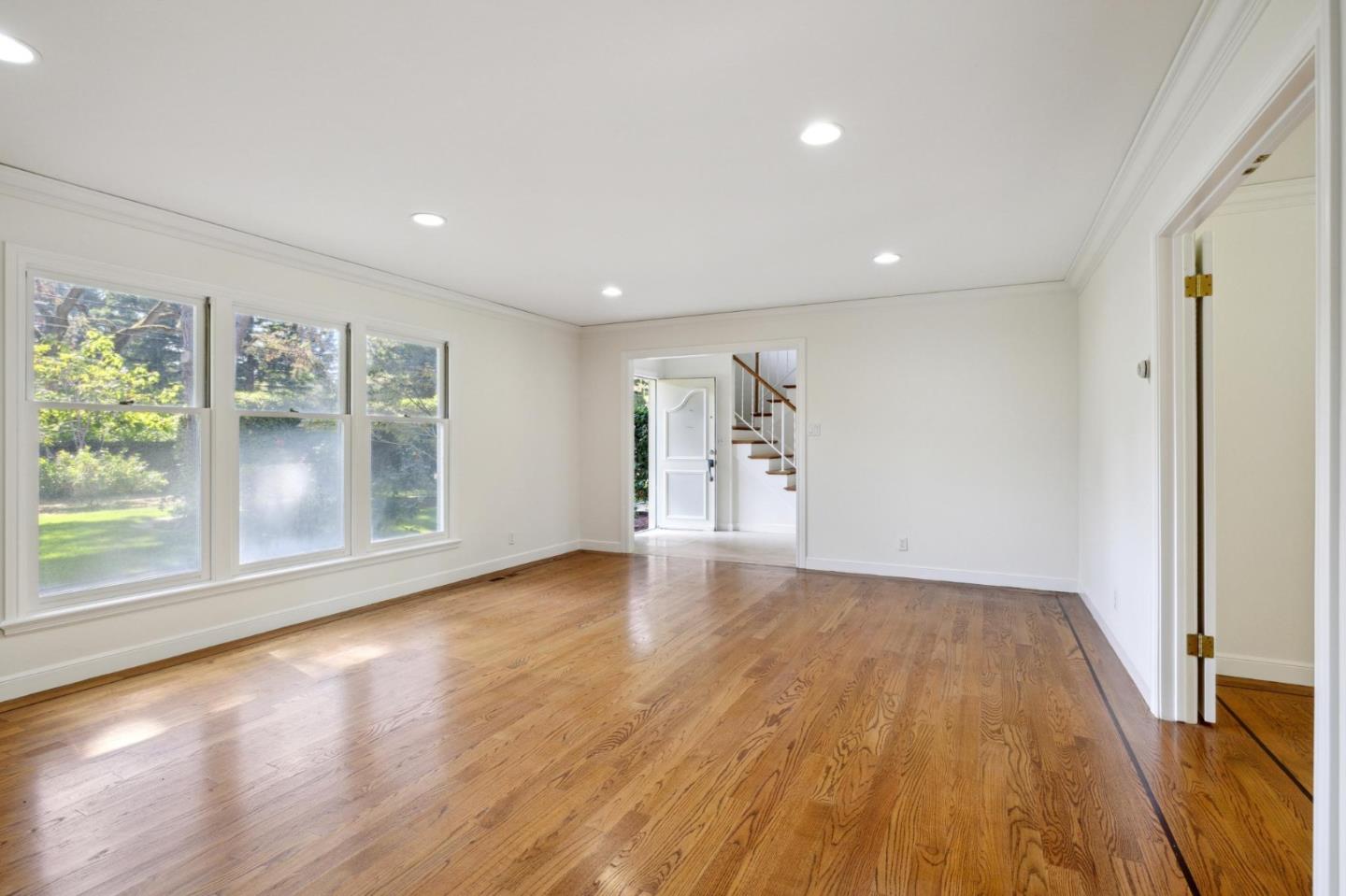 243 Selby Lane Atherton, CA 94027 - Photo 14 of 90 a view of empty room with wooden floor and fan