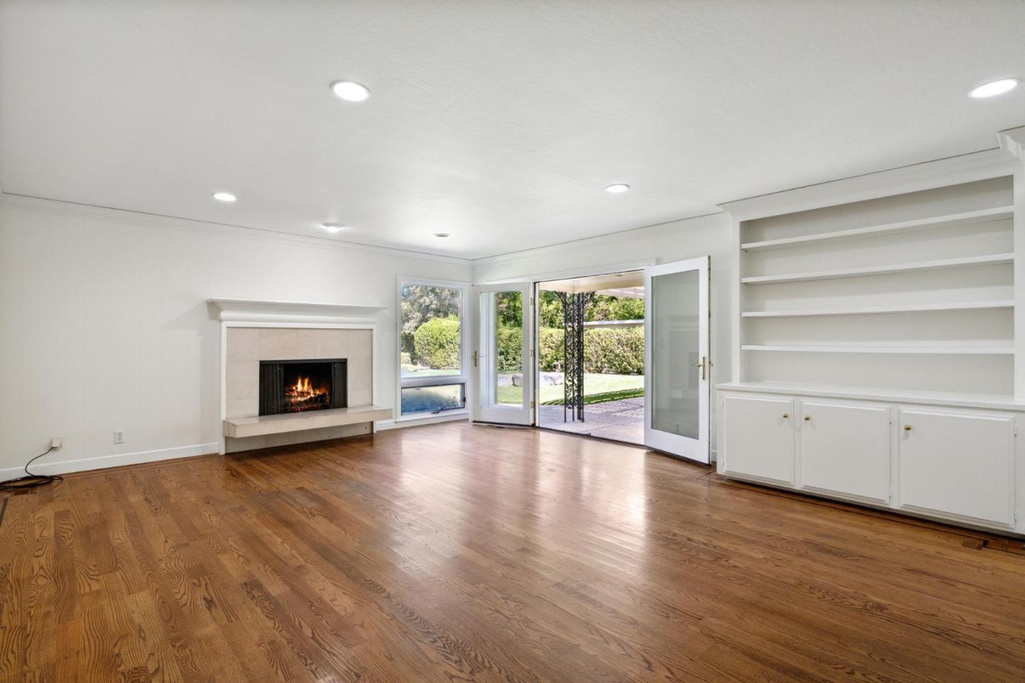 243 Selby Lane Atherton, CA 94027 - Photo 24 of 90 a view of an empty room with a fireplace and a window