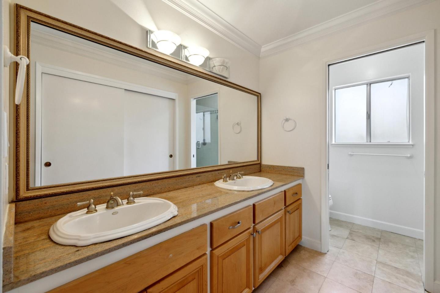 243 Selby Lane Atherton, CA 94027 - Photo 38 of 90 a bathroom with a granite countertop sink and a mirror