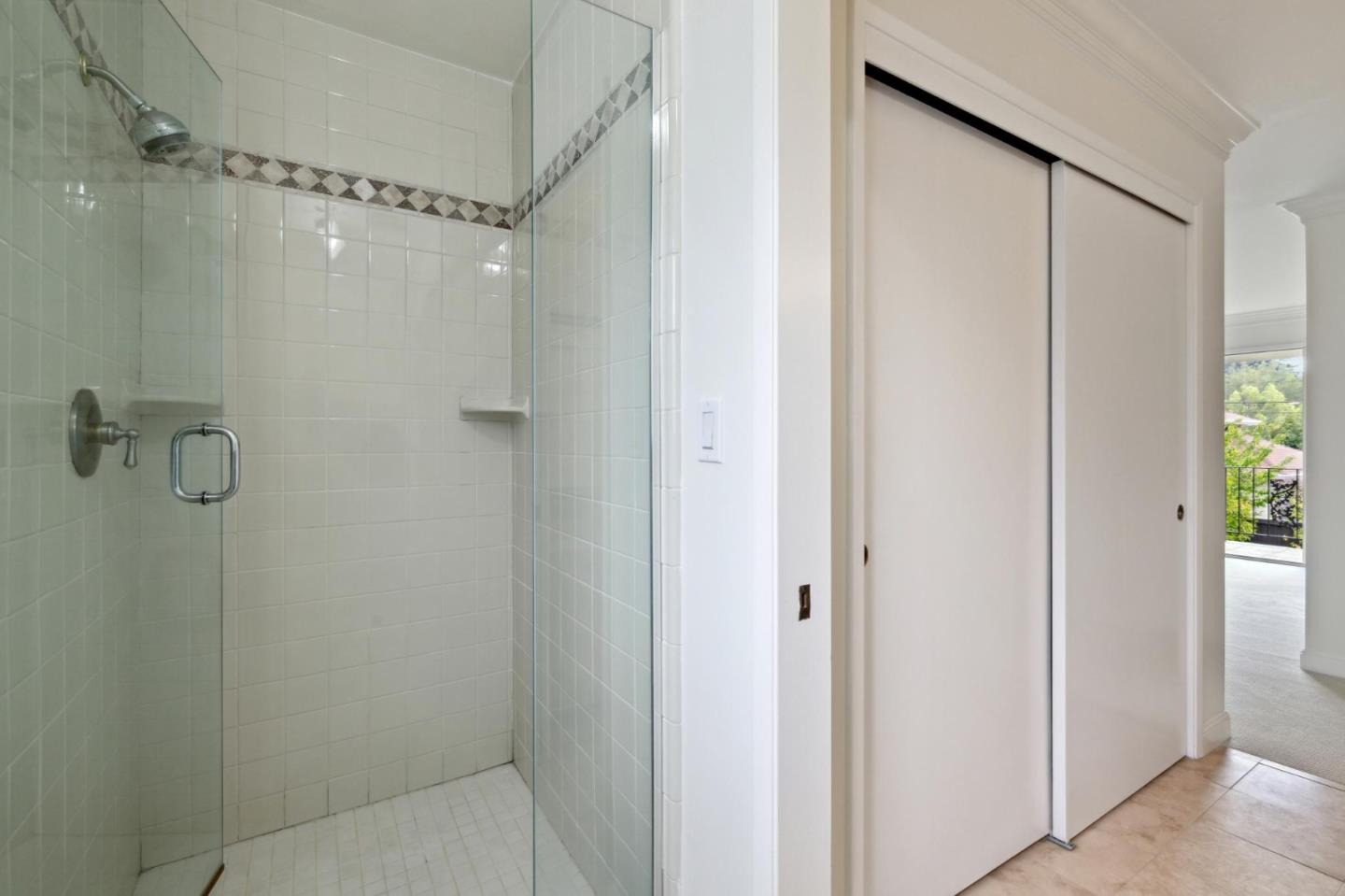 243 Selby Lane Atherton, CA 94027 - Photo 39 of 90 a bathroom with a glass shower door