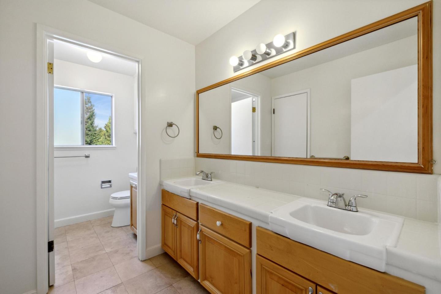 243 Selby Lane Atherton, CA 94027 - Photo 52 of 90 a bathroom with a double vanity sink and mirror with toilet