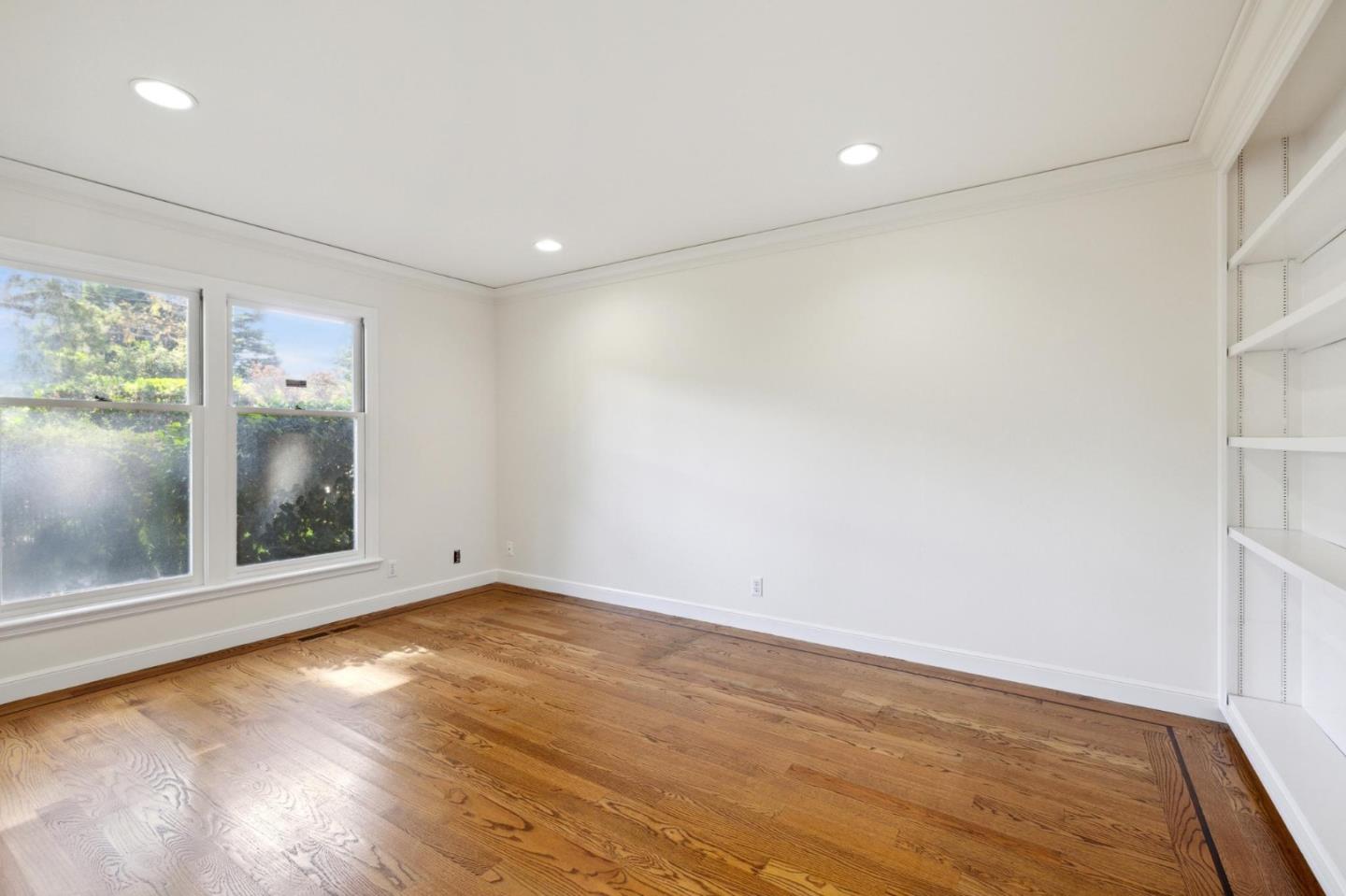 243 Selby Lane Atherton, CA 94027 - Photo 54 of 90 an empty room with wooden floor and windows