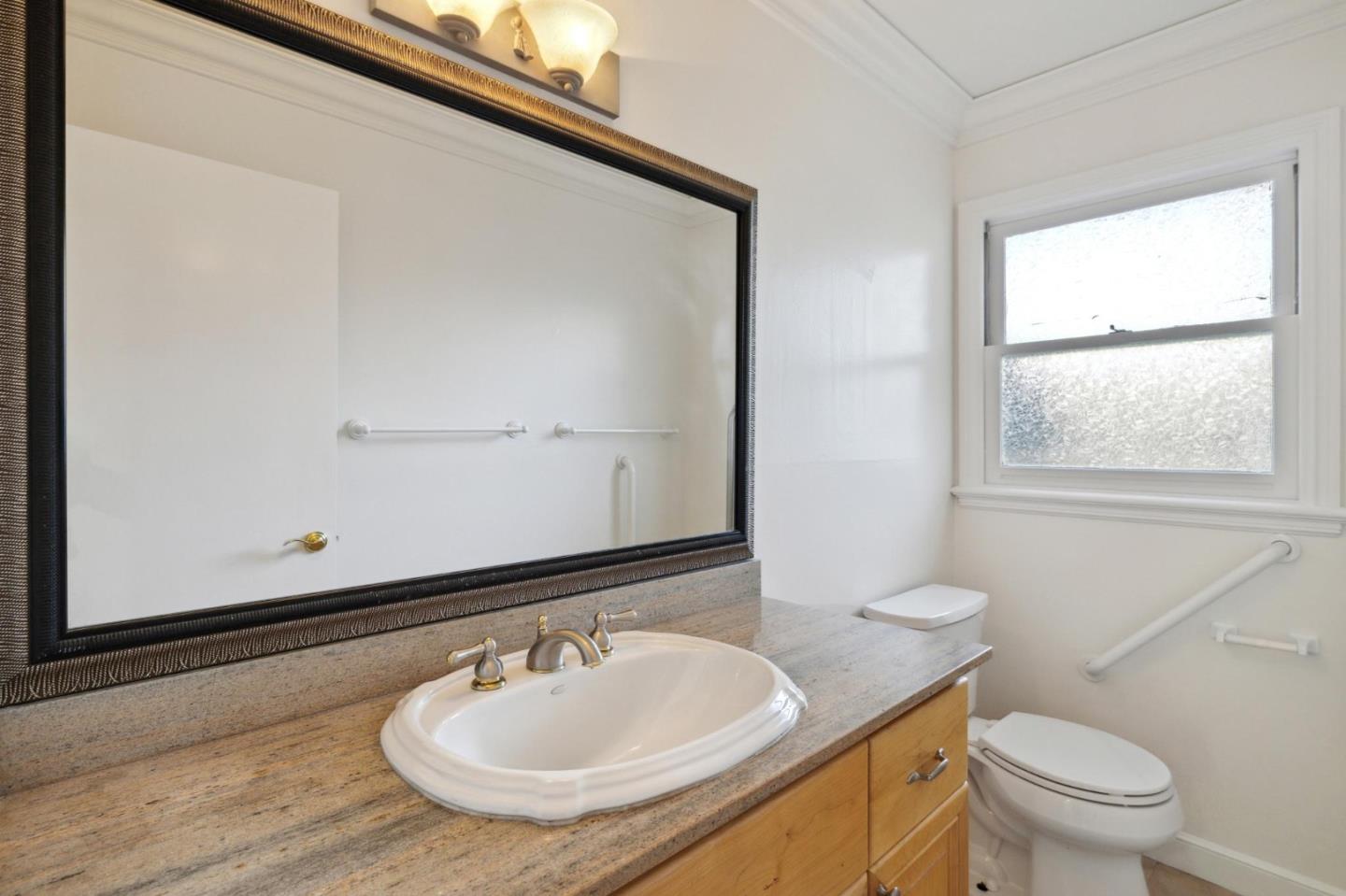 243 Selby Lane Atherton, CA 94027 - Photo 56 of 90 a bathroom with a sink a mirror and a toilet