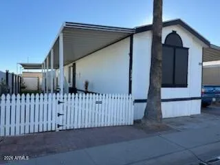 a view of a house with a fence