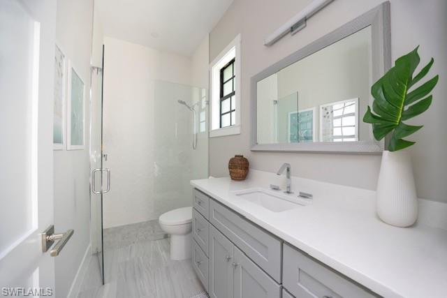 Undisclosed Address Naples, FL 34110 - Photo 12 of 18 a bathroom with a sink a toilet and a mirror