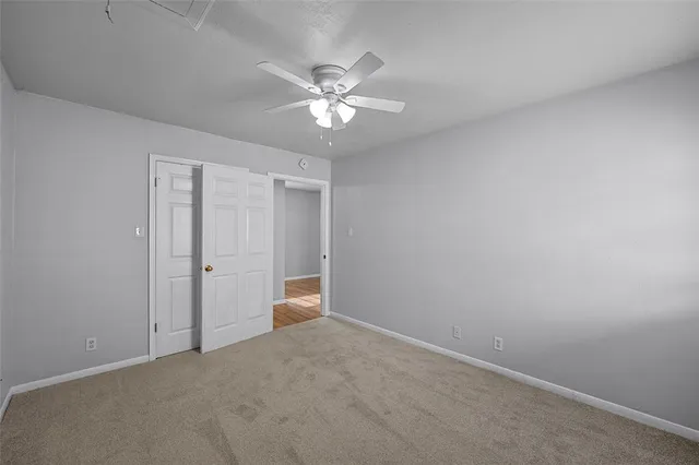 a view of an empty room with a fan