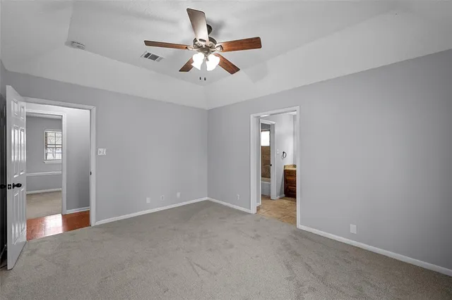 a view of a livingroom with a ceiling fan and window