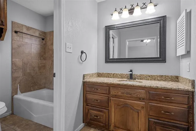 a bathroom with a granite countertop sink a mirror and a